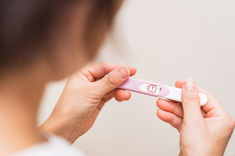 妊娠検査薬を確認する女性